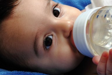 baby drinking water from a bottle