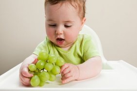 baby eating grapes